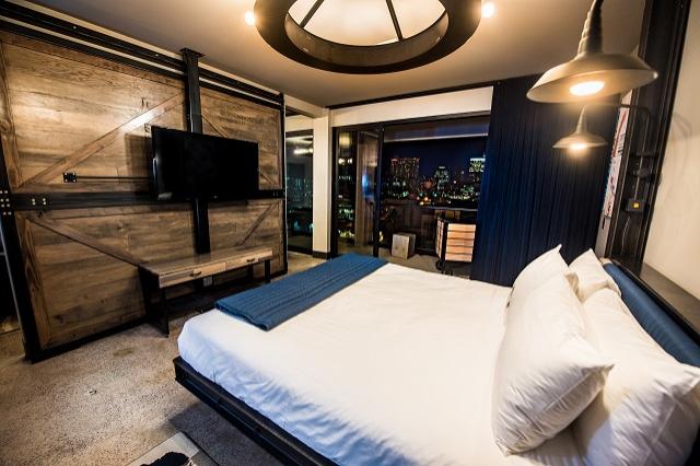 Suite bedroom with city view at night